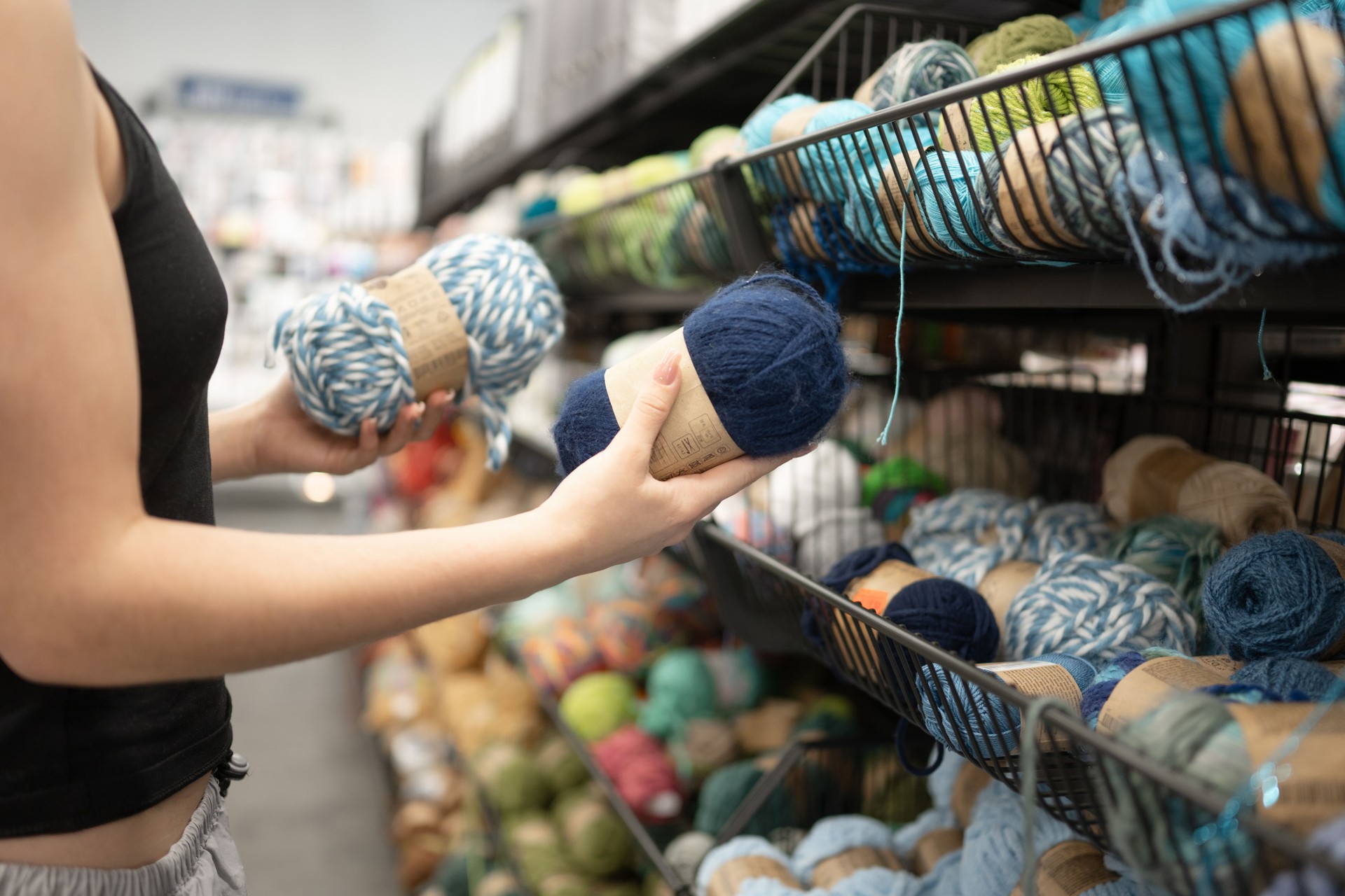 Young Girl Choosing Yarn In Store